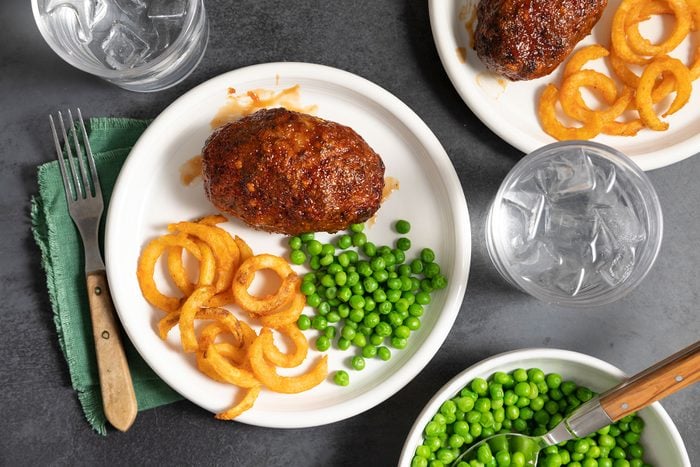 Air Fryer Meat Loaf served with onion rings and peas 