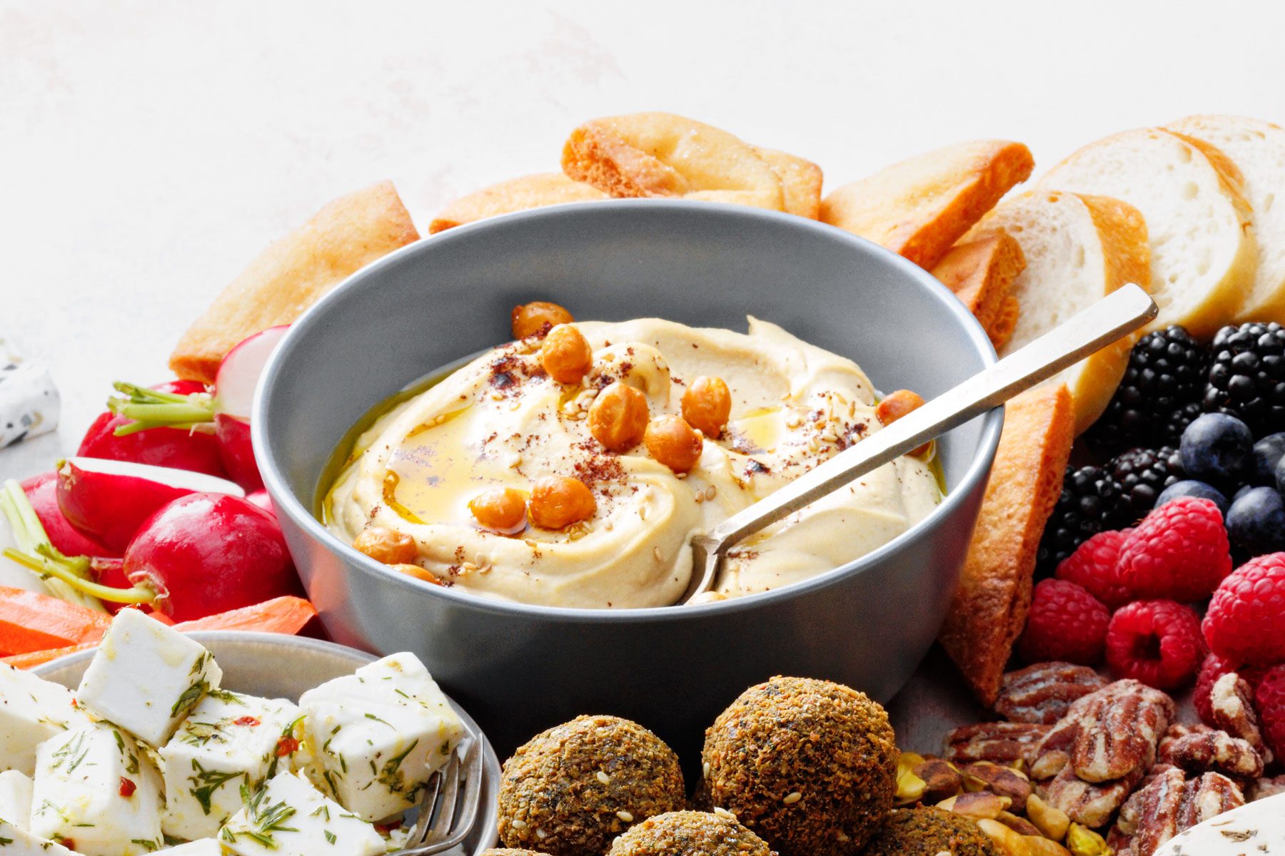 Hummus and other food served together in a large plate