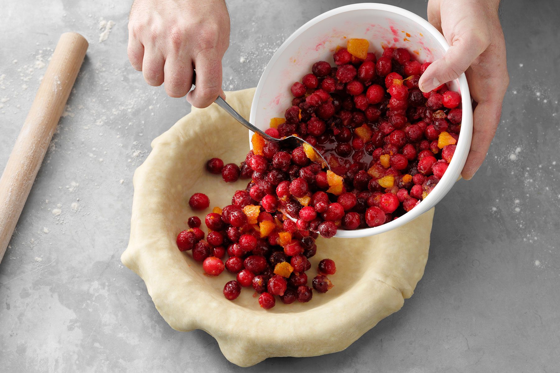 Putting cranberry mix in flattened out pie dough