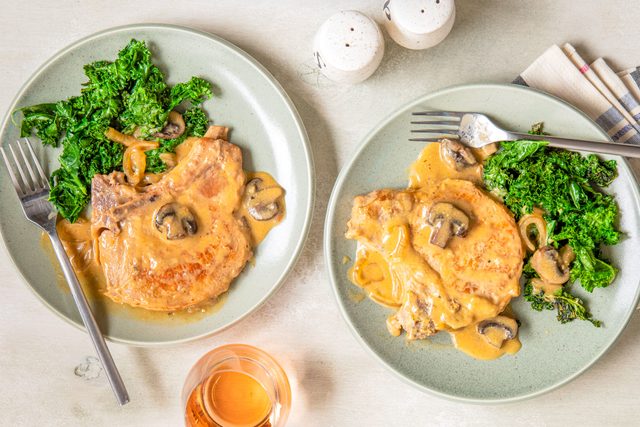 Crockpot Smothered Pork Chops Served in Two Plates with Two Forks