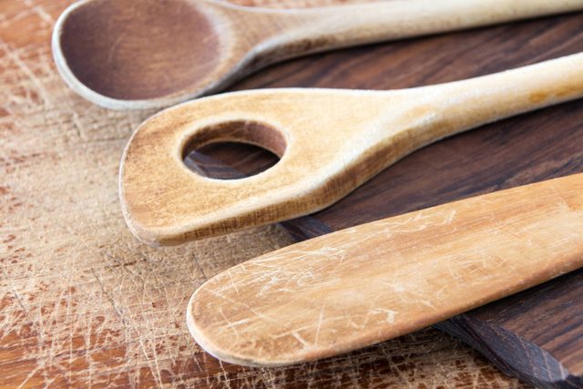 Wooden cooking spoon on wood background