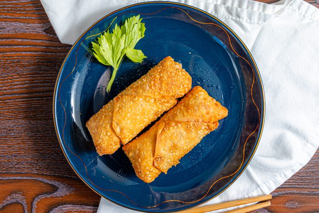egg roll on a blue plate with a towel
