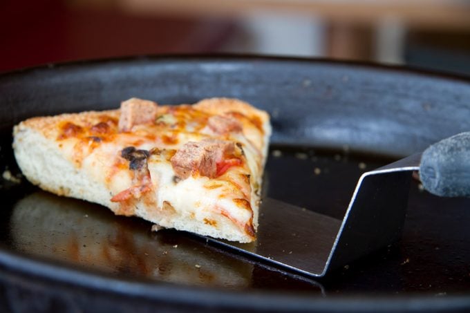 slice of pizza being removed from a pan