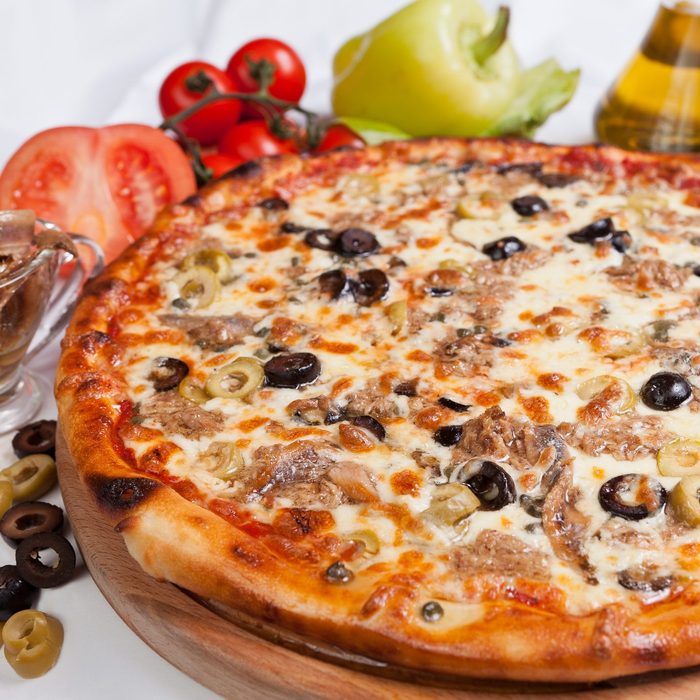 Pizza marinara on a white background with ingredients around