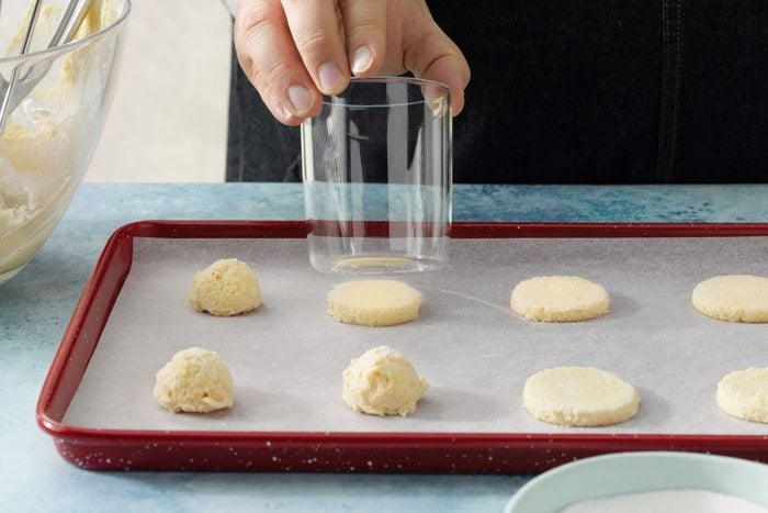 Flatten cookies with bottom of glass