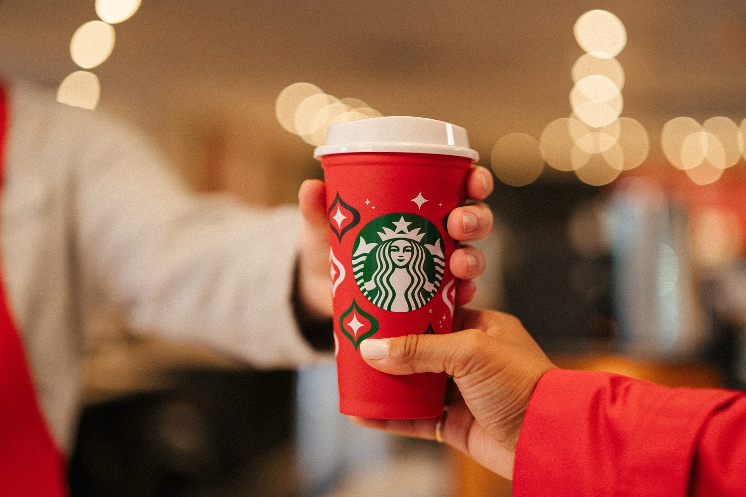 Starbucks Reusable Holiday Red Cups 2023 Lifestyle 2 Courtesy Starbucks