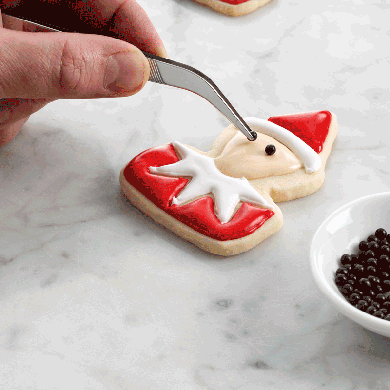 decorating santa elf cookie face gif