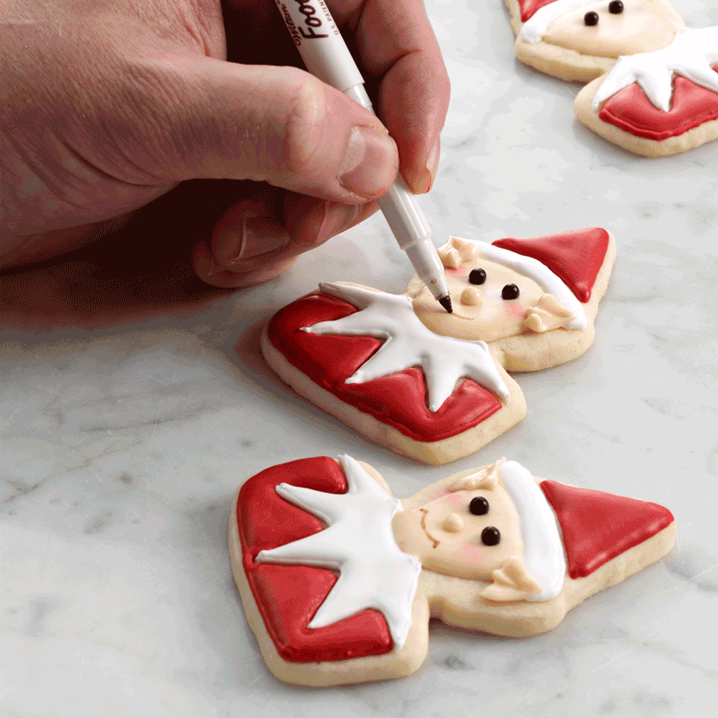 finishing touches with decorating santa cookie elf gif
