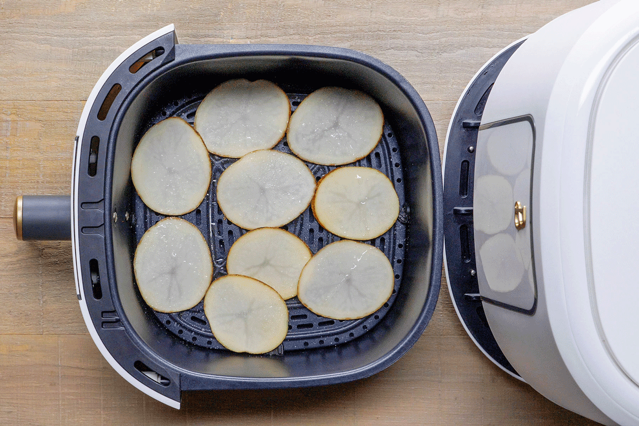 Putting slices of Potato Chips in Air Fryer 