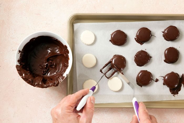 Dip the peppermint patties in chocolate with fork