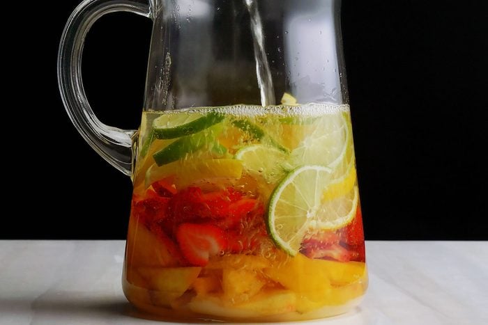 Adding Soda to jug filled with fruits