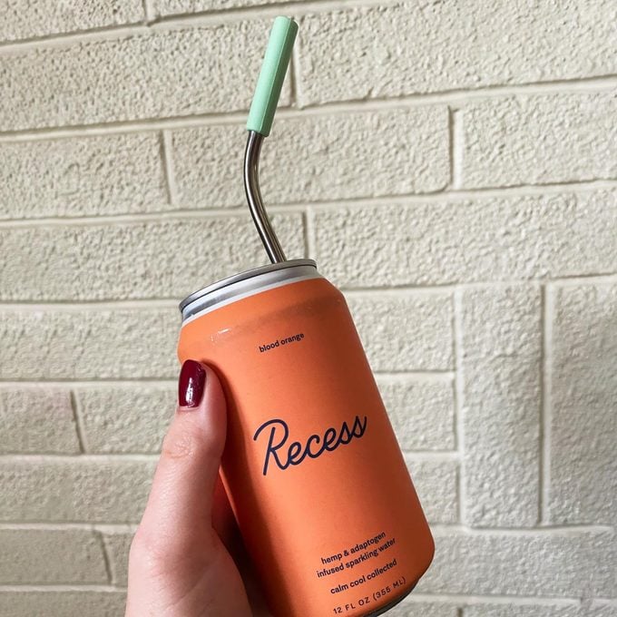 Blood Orange Recess Can flovor with a metal straw