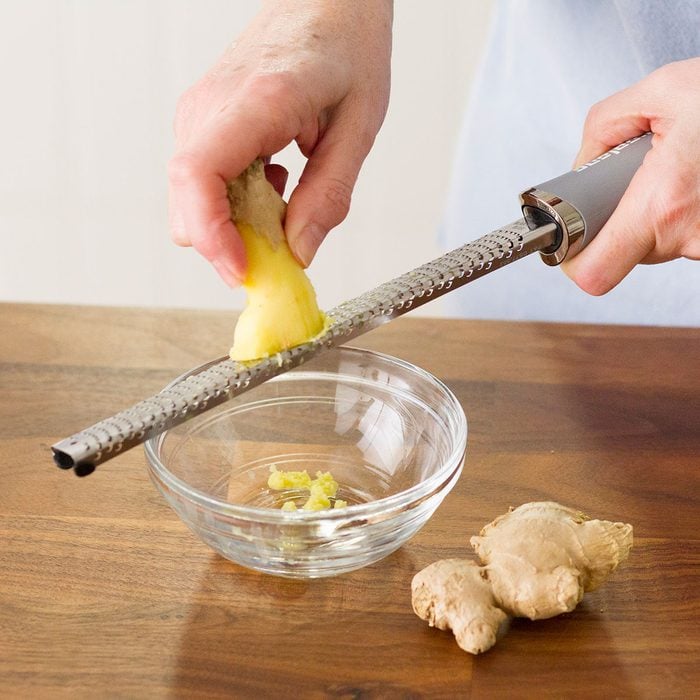 Grating Ginger in a small bowl