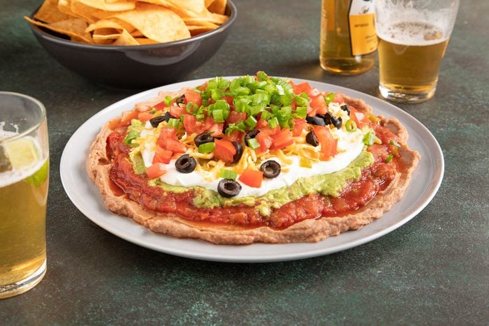 7 Layer Dip served with glass of beer