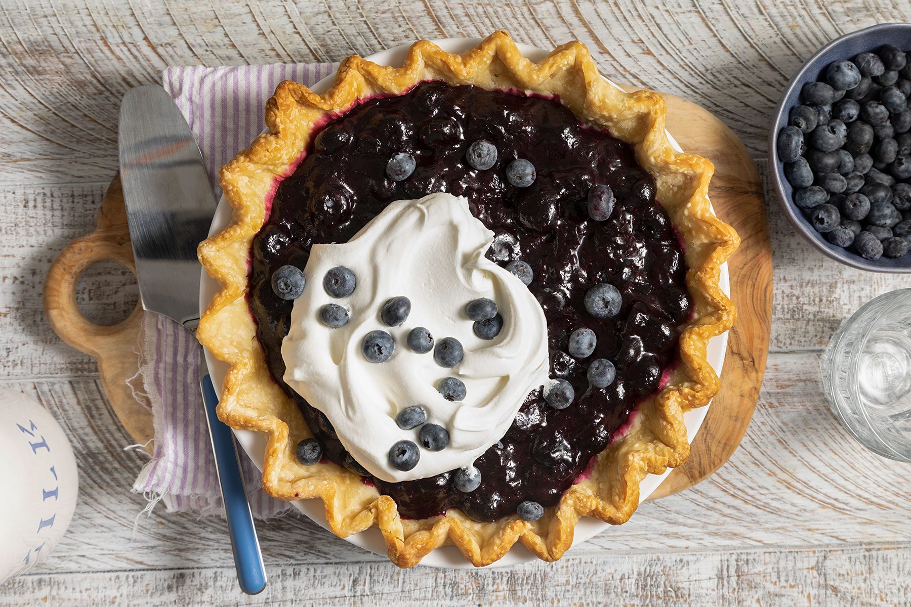 Blueberry Pie topped with whipped cream and blueberries