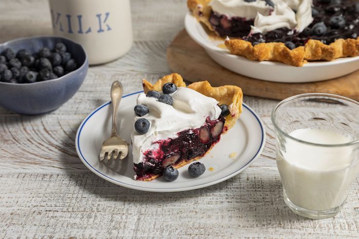 Blueberry Pie served on plate with milk