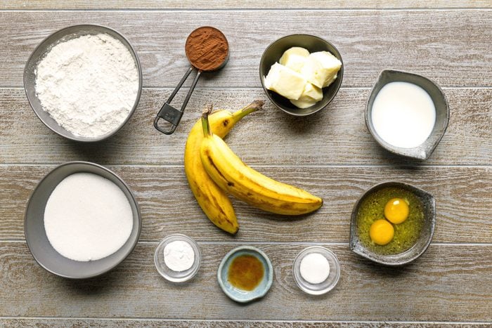 Bananas eggs Baking cocoa and other ingredients placed on a wooden table