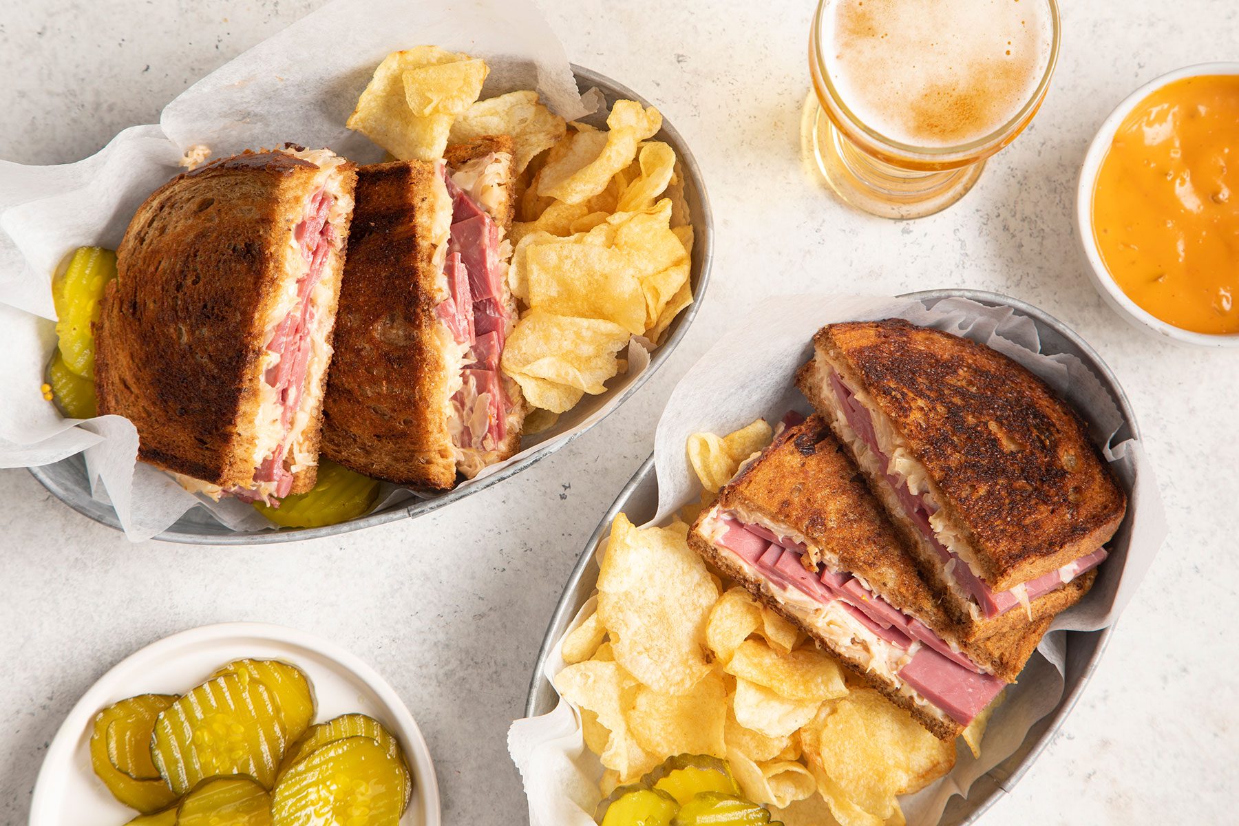 Corned Beef Sandwiches served on plate with beverage