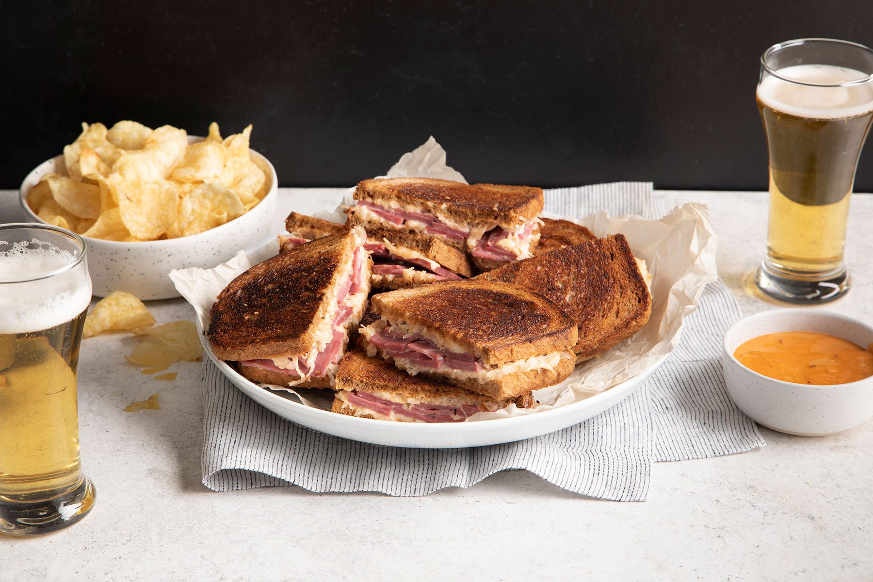 Corned Beef Sandwiches served with chips, dip and beverages