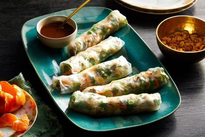 Fresh Spring Rolls served on blue plate with sauce 