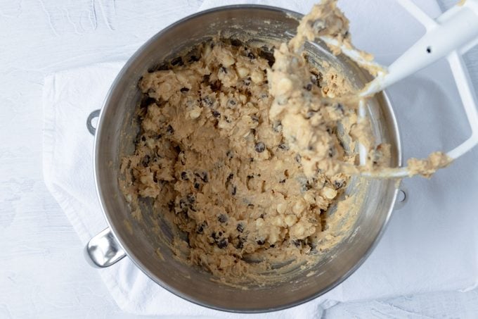 Chocolate chips and other ingredients mixed in a large bowl