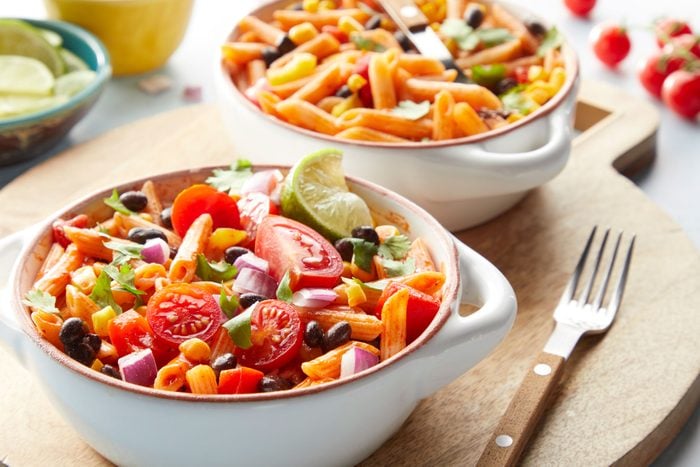One Pot Enchilada Pasta tomatoes and other veges served in a bowl