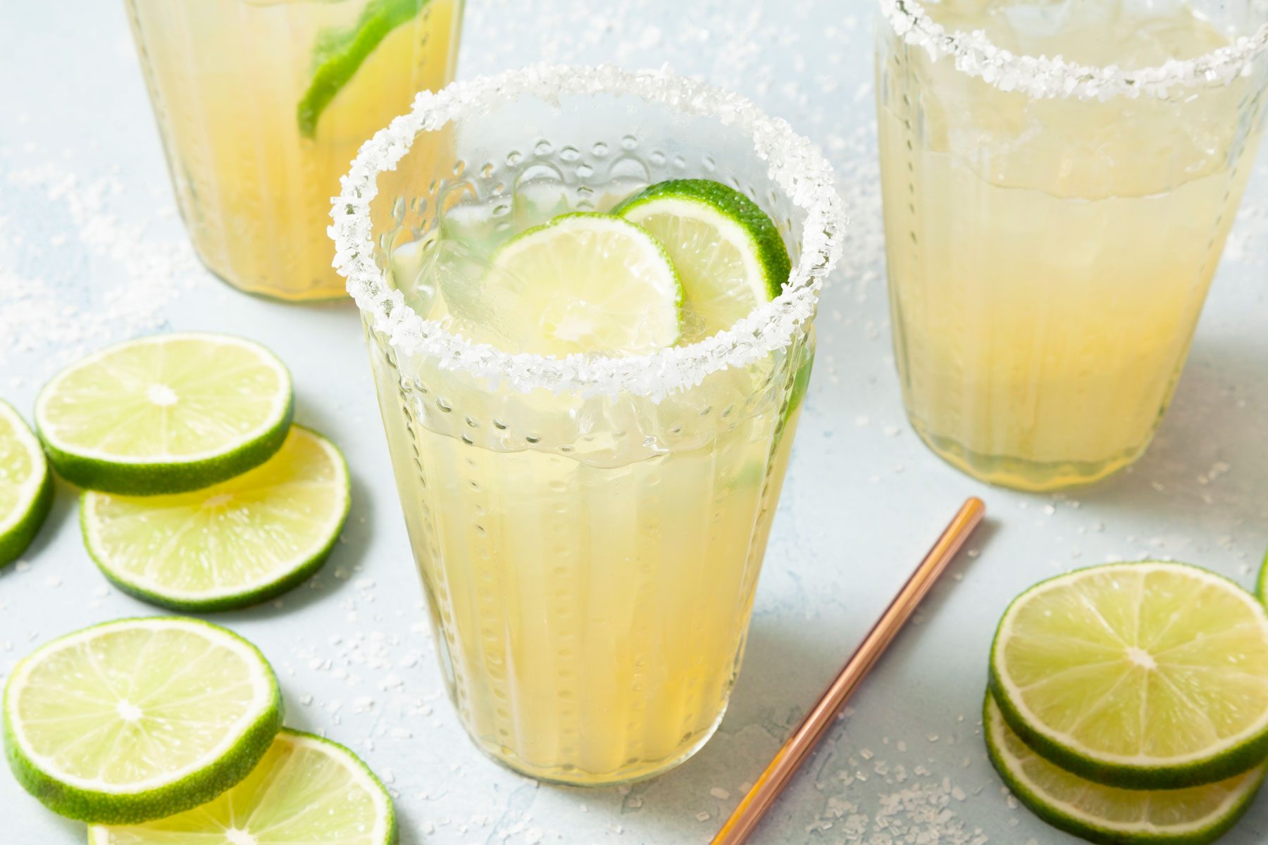 Cups of Refreshing Beer Margaritas with slices of lemon on side