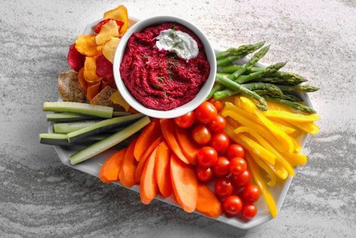 Roasted Beetroot And Garlic Hummus ina plate with other vegetables