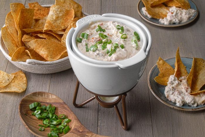 Sausage Cream Cheese Dip served with chips placed on a wooden surface