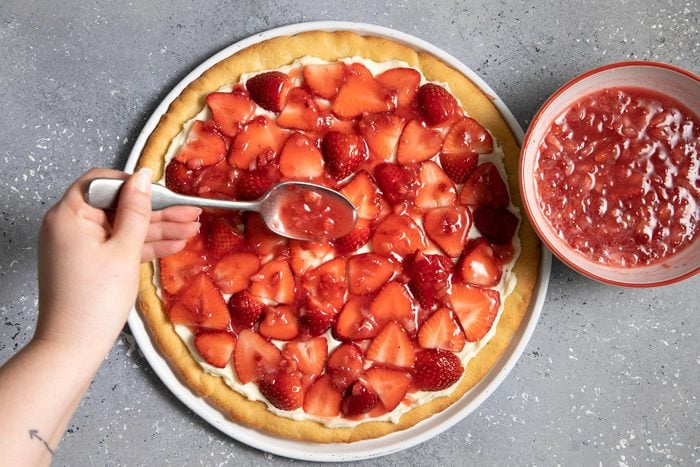Glazing syrup on sliced strawberries