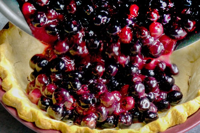 Adding cooked blueberries in dough