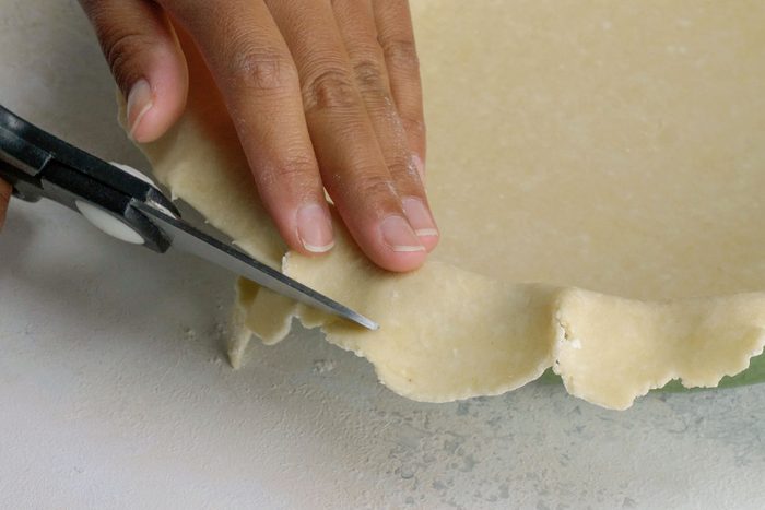 Trimming the dough with scissors