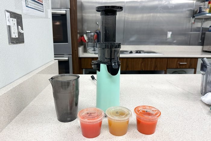 Dash Compact Masticating Slow Juicer with different liquid cups