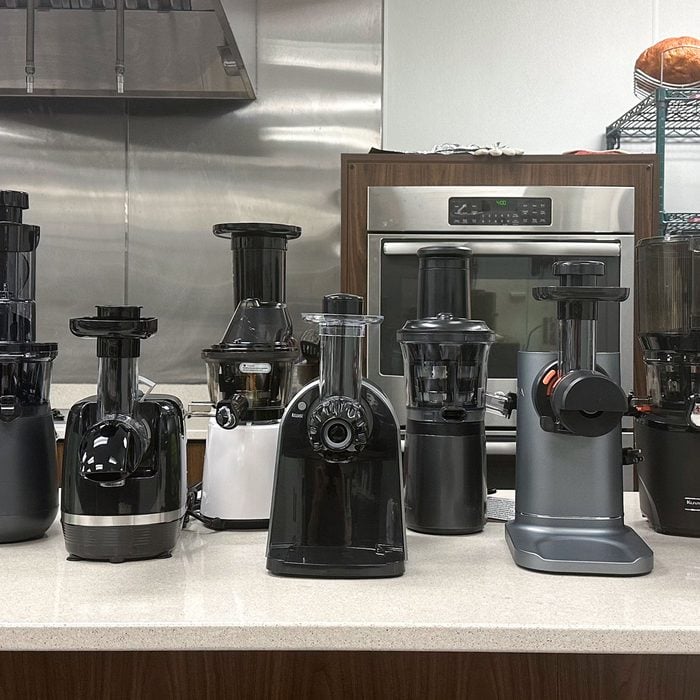 A group of juicers on a counter in a kitchen.