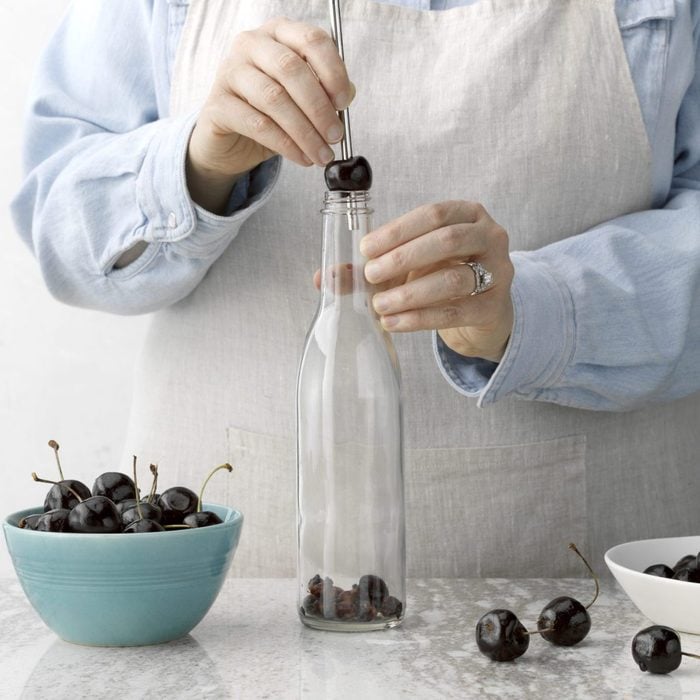 Removing seed from cherry in a glass bottle