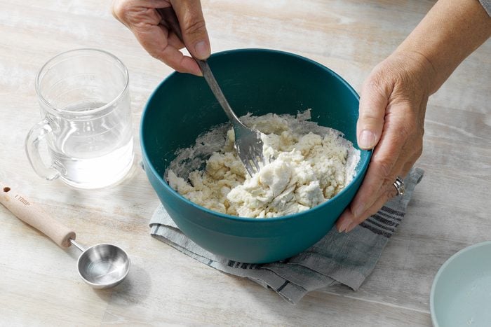 A person mixing ingredients in a bowl