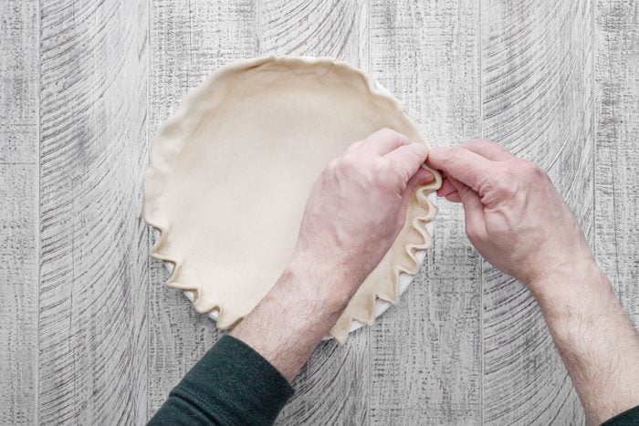 Transfer the rolled out dough to the pie plate and flute the edges