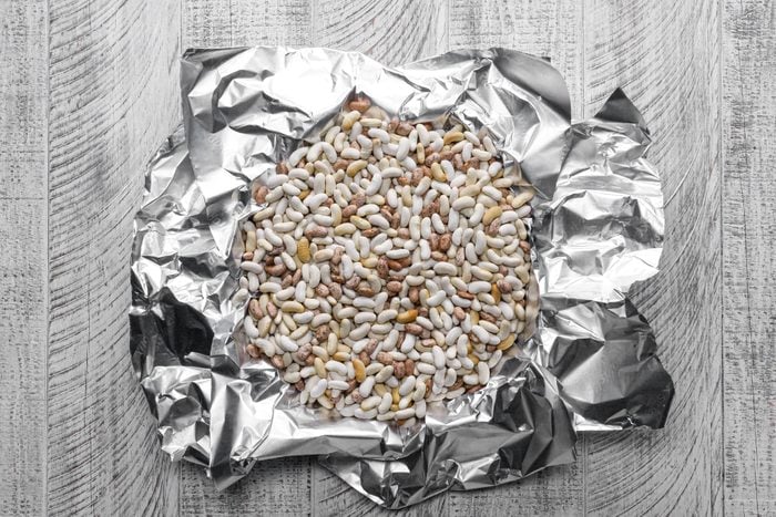 Line the crust with foil filled with beans and rice