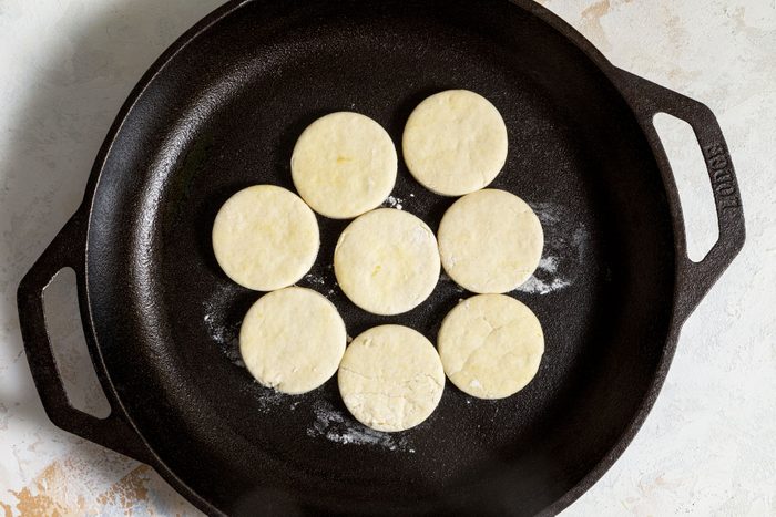 Cooking the biscuits on a large skillet
