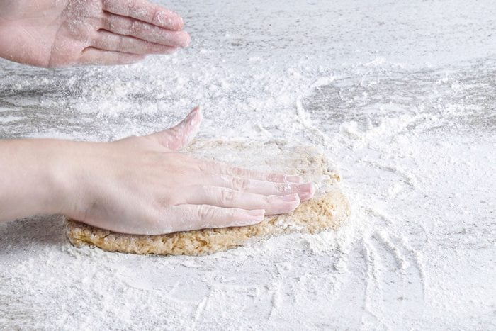 Flattening the dough on surface