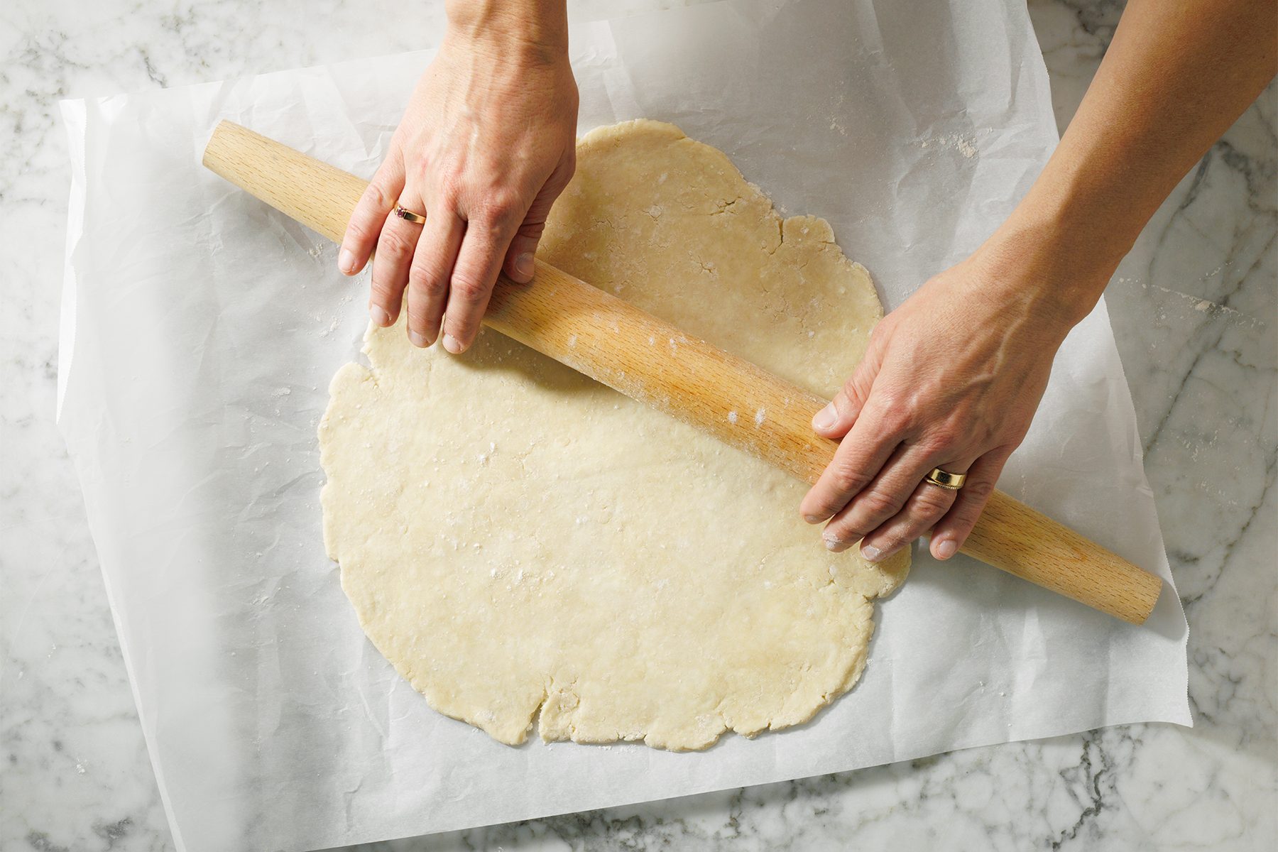 A person is rolling a dough