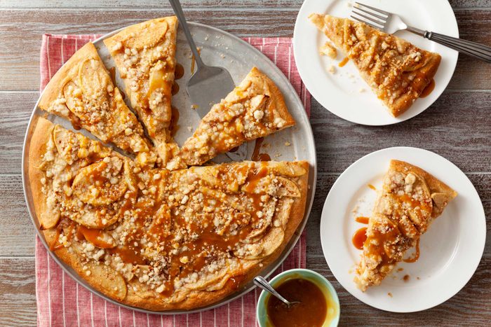 Delicious Apple Pizza topped with caramel drizzle on a crispy crust