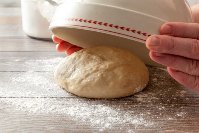 Place the dough on a floured surface and cover it with a bowl