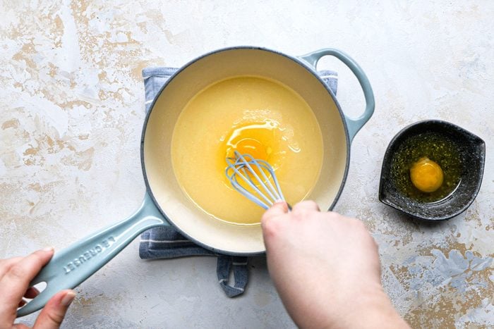 Mixing the egg in a large saucepan with a spatula