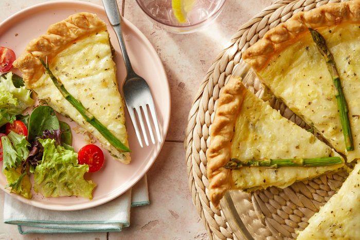 Asparagus Quiche slice served in a small plate with veges