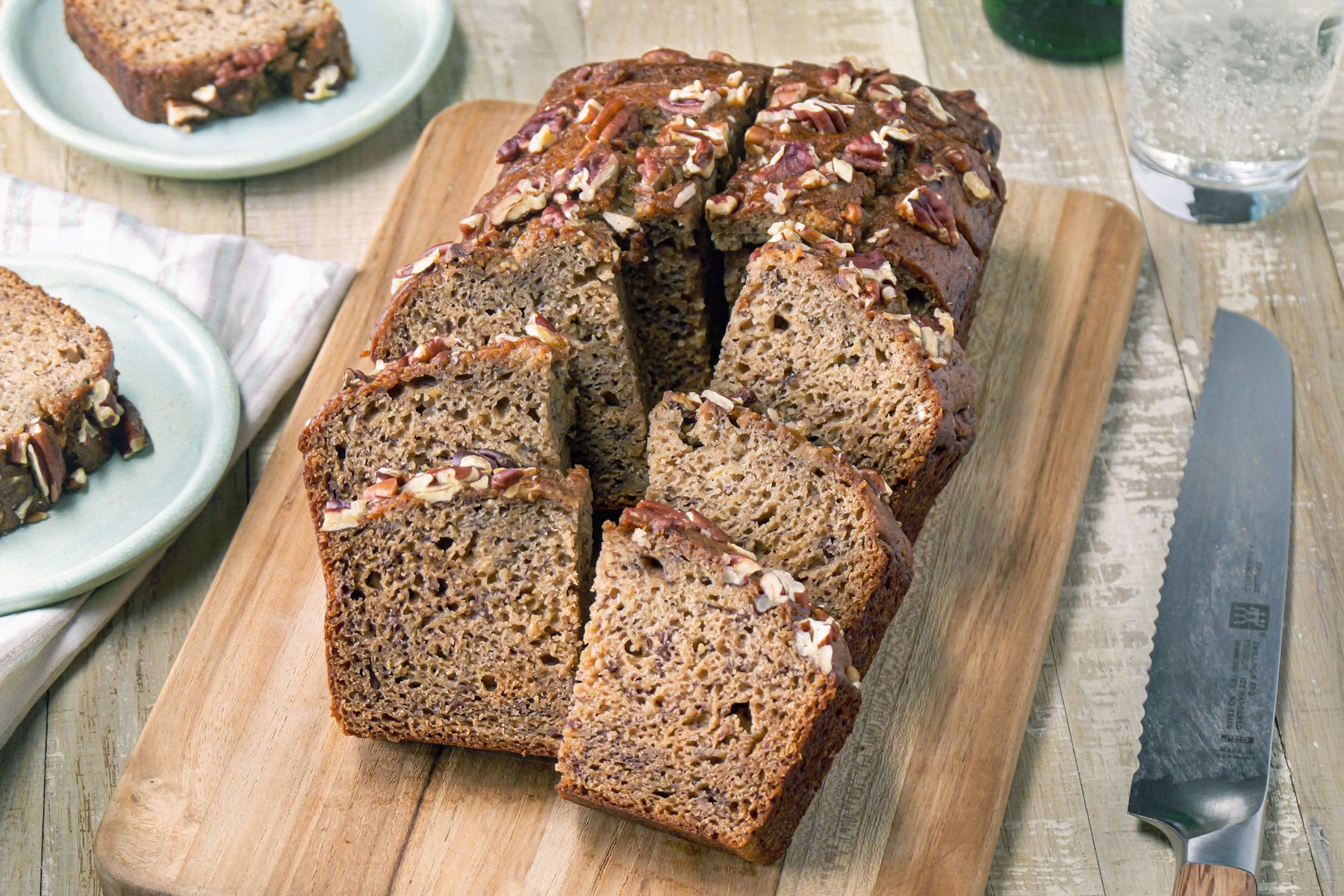 A loaf of Banana Nut Bread on a wooden board.