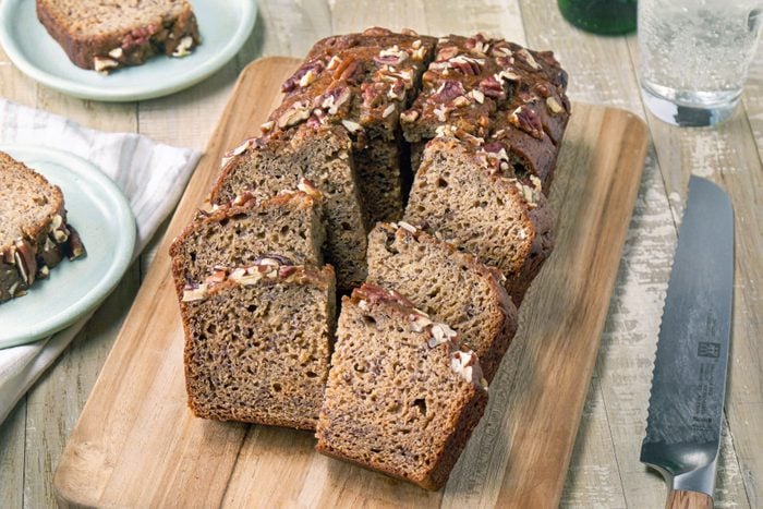 A loaf of Banana Nut Bread on a wooden board.