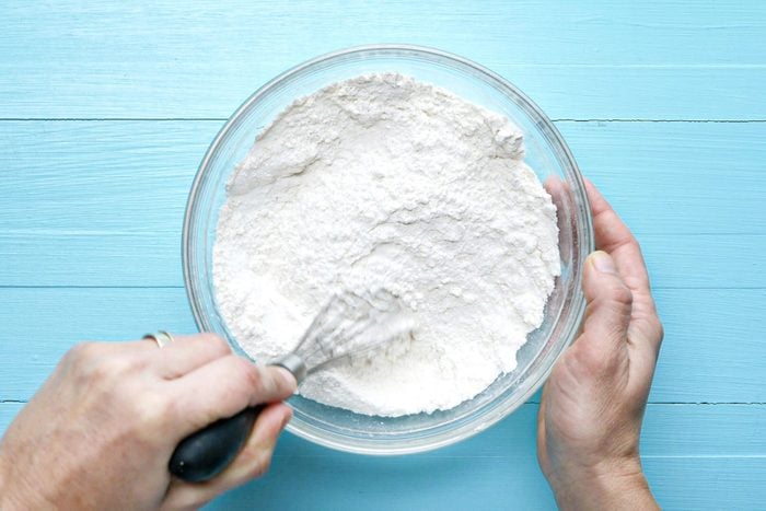 Whisking flour and sugar in a large bowl