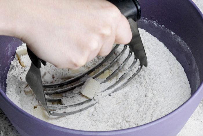mixing butter with flour using pastry blender