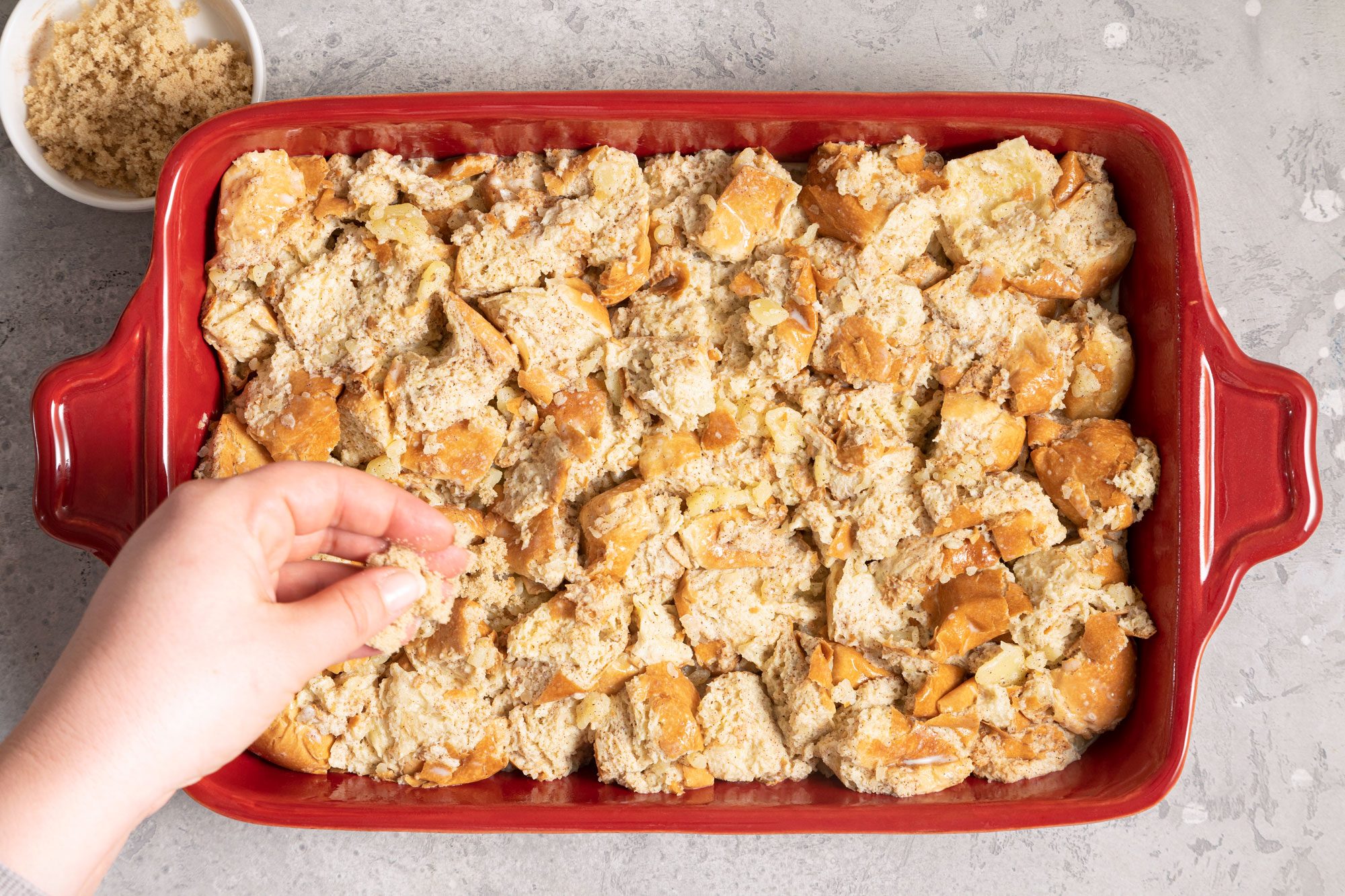 wet bread cubes in a large red baking dish